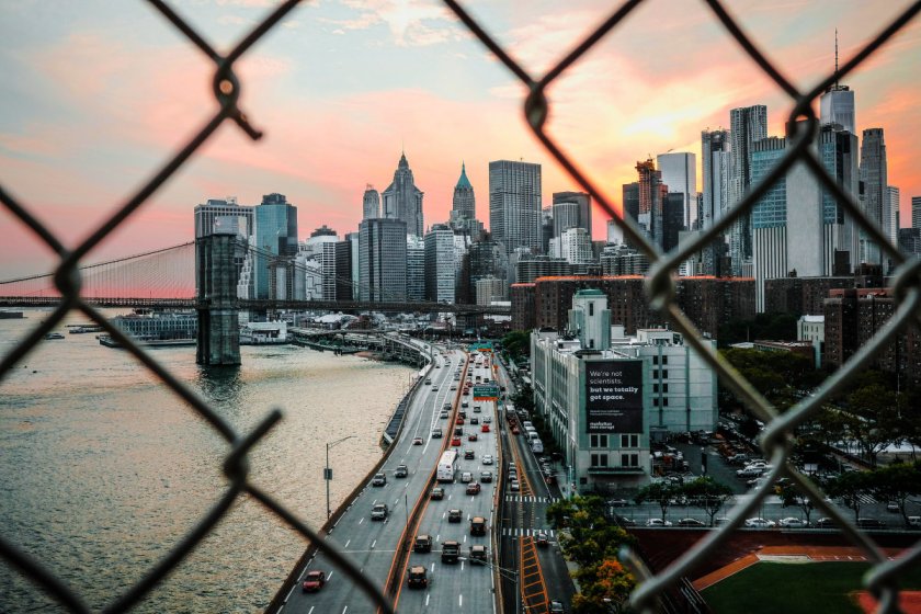 New York City seen through a hole in metal wire fence