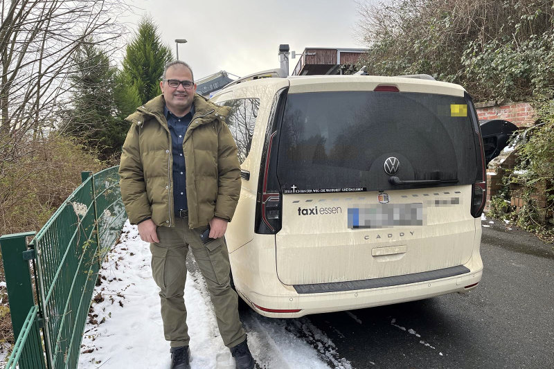 Jalil Mashali standing beside his Taxi cab in Essen, Germany