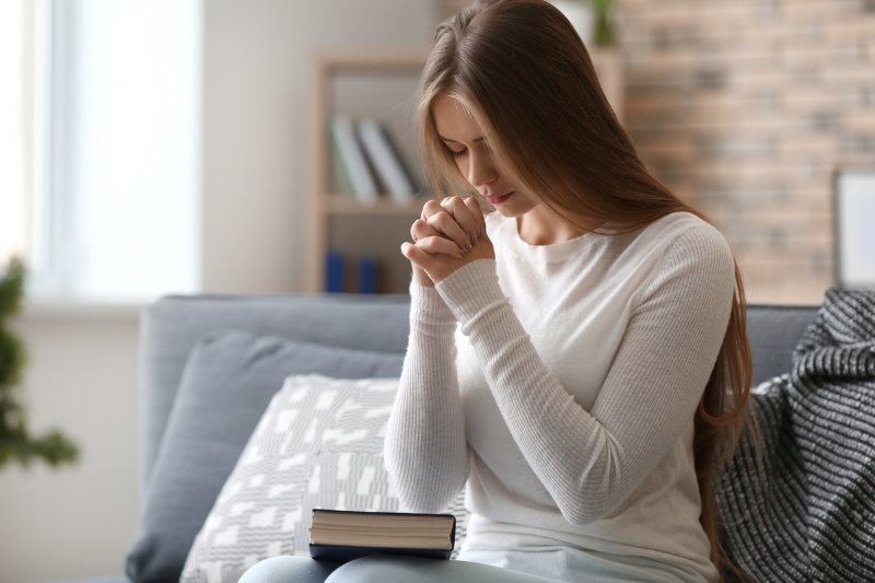 Woman praying at home