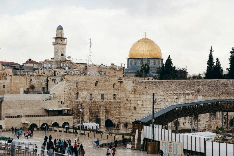 The Western Wall in Jerusalem, with the Temple Mount and Dome of the Rock in the background.