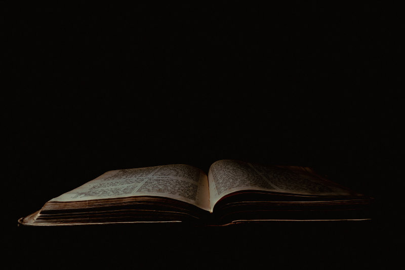 Open Bible on dark background